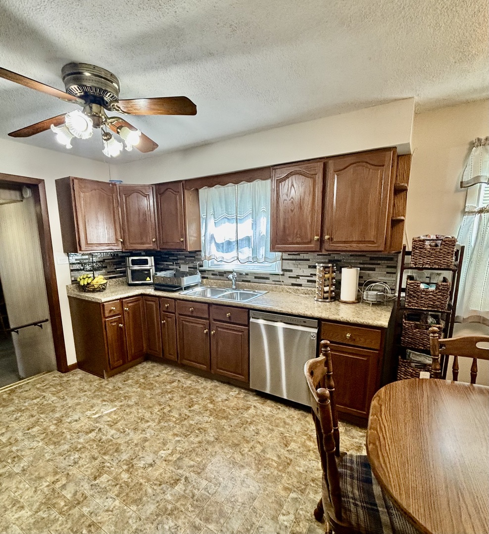 6737 104th Place Chicago Ridge, IL 60415 - Photo 18 of 32 a kitchen with stainless steel appliances granite countertop a refrigerator a stove top oven a sink dishwasher and wooden cabinets