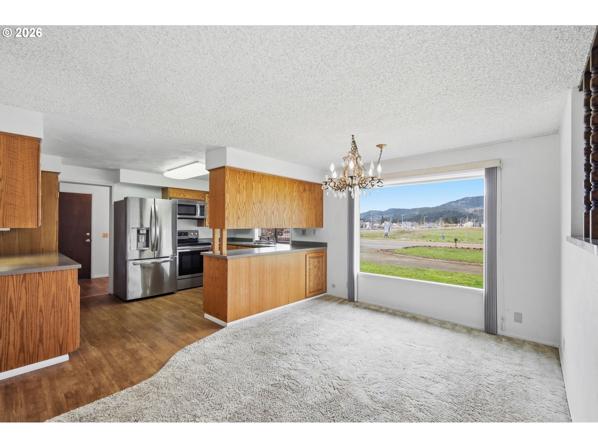 2541 Marcola Road Springfield, OR 97477 - Photo 13 of 33 a view of a kitchen with refrigerator and a stove top oven