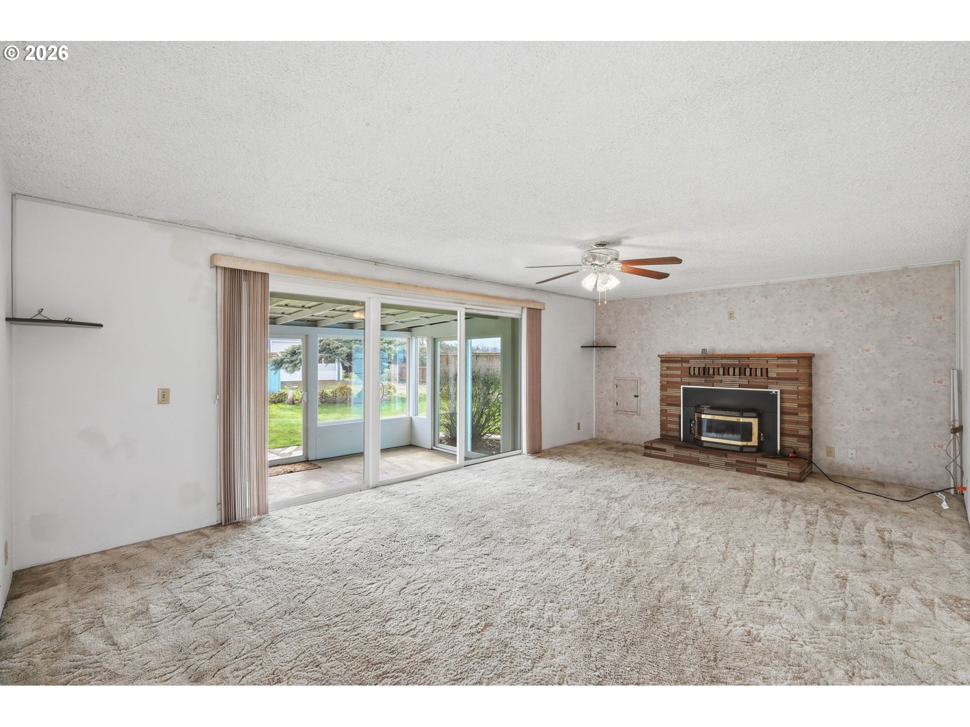 2541 Marcola Road Springfield, OR 97477 - Photo 16 of 33 a view of an empty room with a fireplace and a ceiling fan