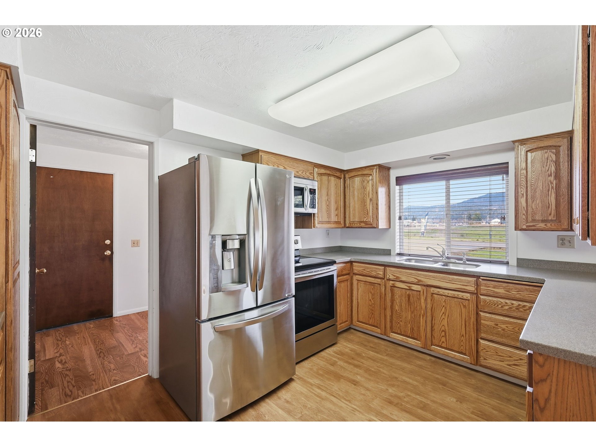 2541 Marcola Road Springfield, OR 97477 - Photo 9 of 33 a kitchen with stainless steel appliances granite countertop a refrigerator and a sink