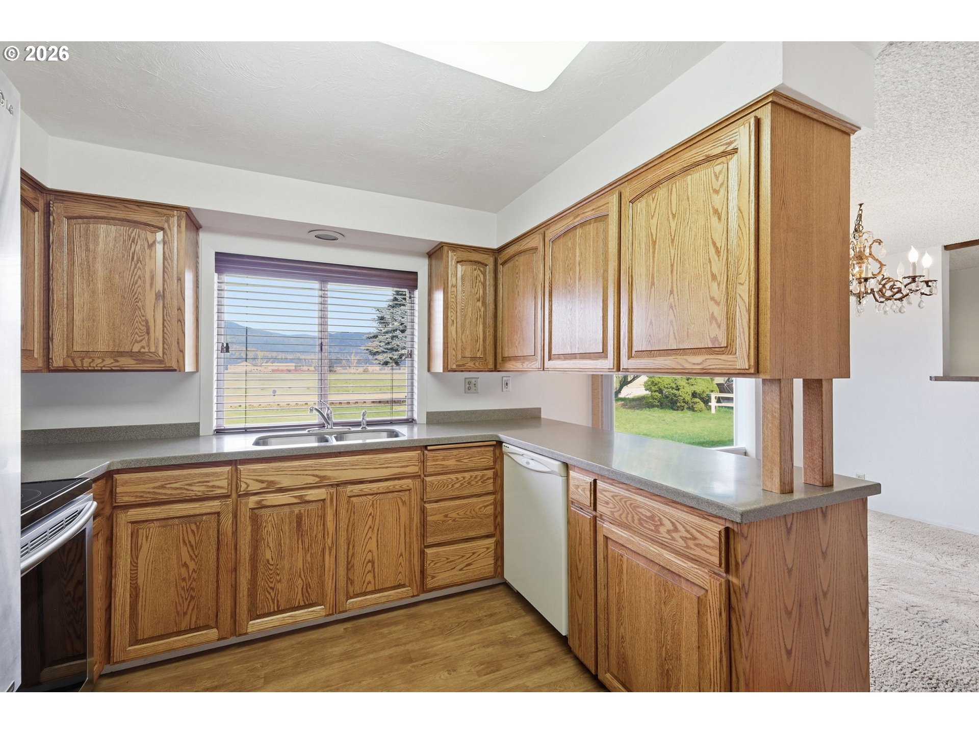 2541 Marcola Road Springfield, OR 97477 - Photo 10 of 33 a kitchen with a sink window and cabinets