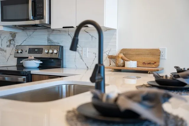 a kitchen with a faucet a sink and a stove
