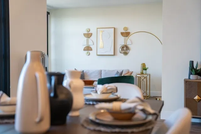 a living room with furniture and a mirror