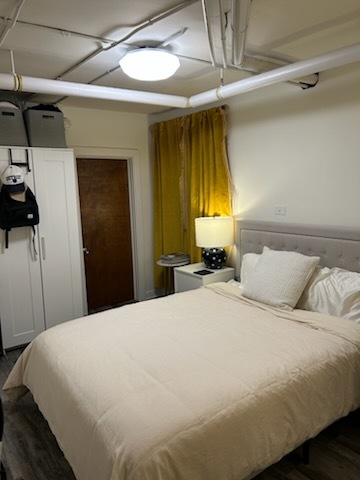 622 West Briar Place, Unit G Chicago, IL 60657 - Photo 11 of 19 a bedroom with a bed and a chandelier