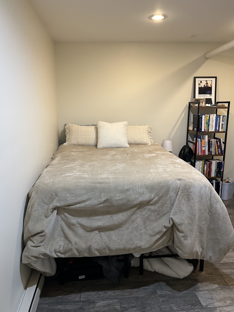 622 West Briar Place, Unit G Chicago, IL 60657 - Photo 6 of 19 a bed sitting in a bedroom next to a book shelf