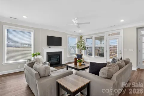 a living room with furniture a large window and a fireplace