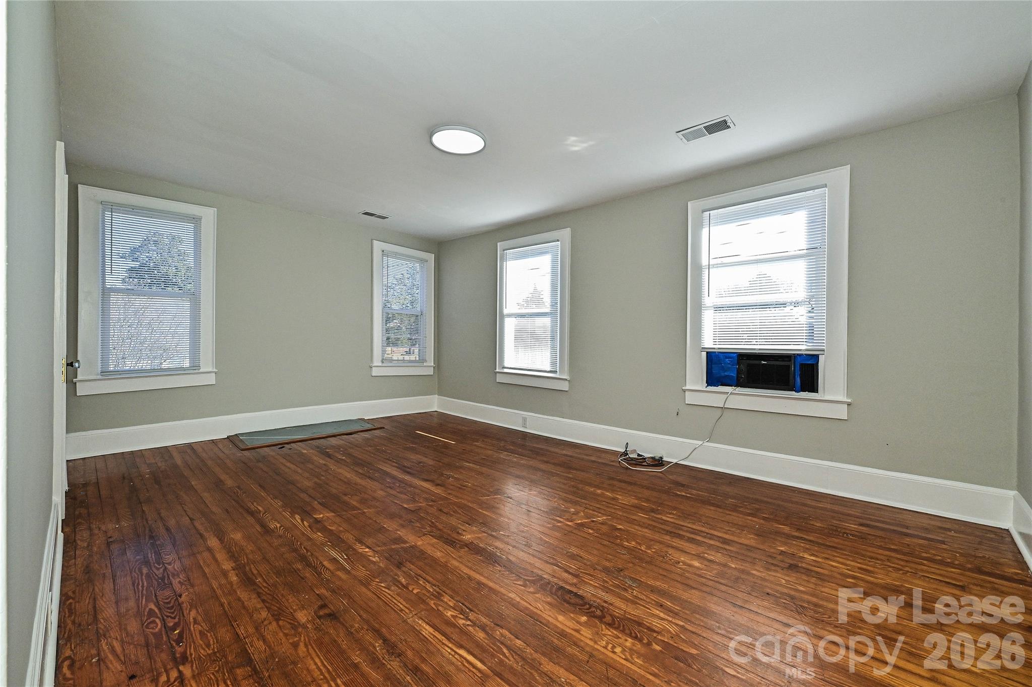 134 Saluda Street, Unit B Chester, SC 29706 - Photo 15 of 21 a view of an empty room with wooden floor and a window
