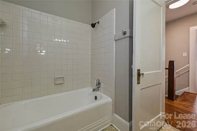 a bathroom with a bathtub and a shower