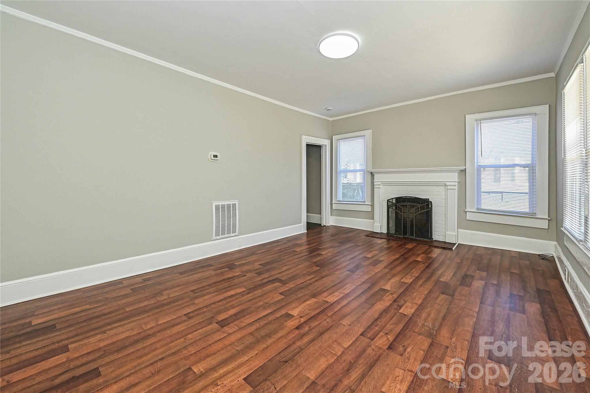 134 Saluda Street, Unit B Chester, SC 29706 - Photo 4 of 21 a view of empty room with wooden floor and fireplace