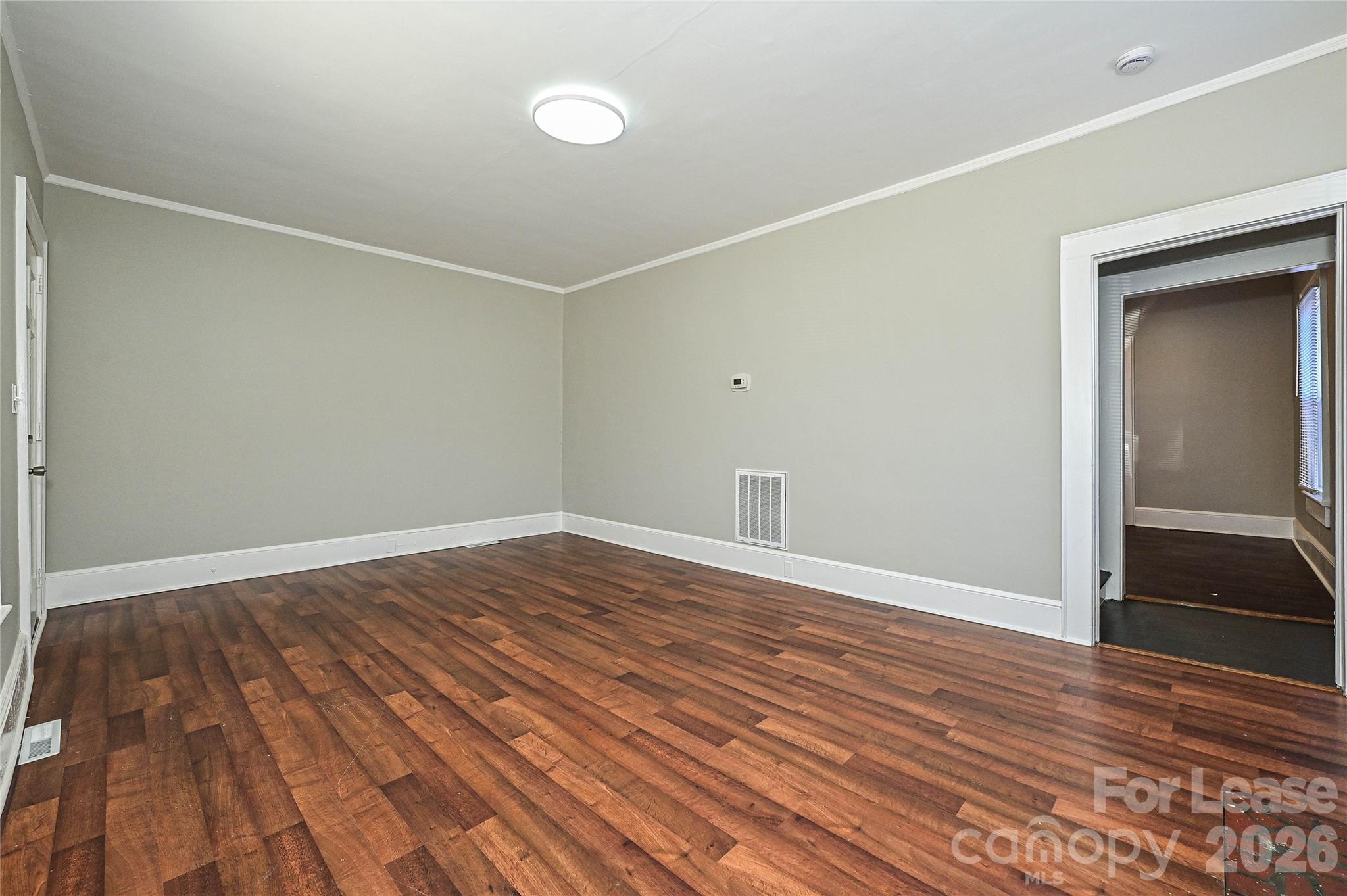 134 Saluda Street, Unit B Chester, SC 29706 - Photo 5 of 21 a view of empty room with wooden floor