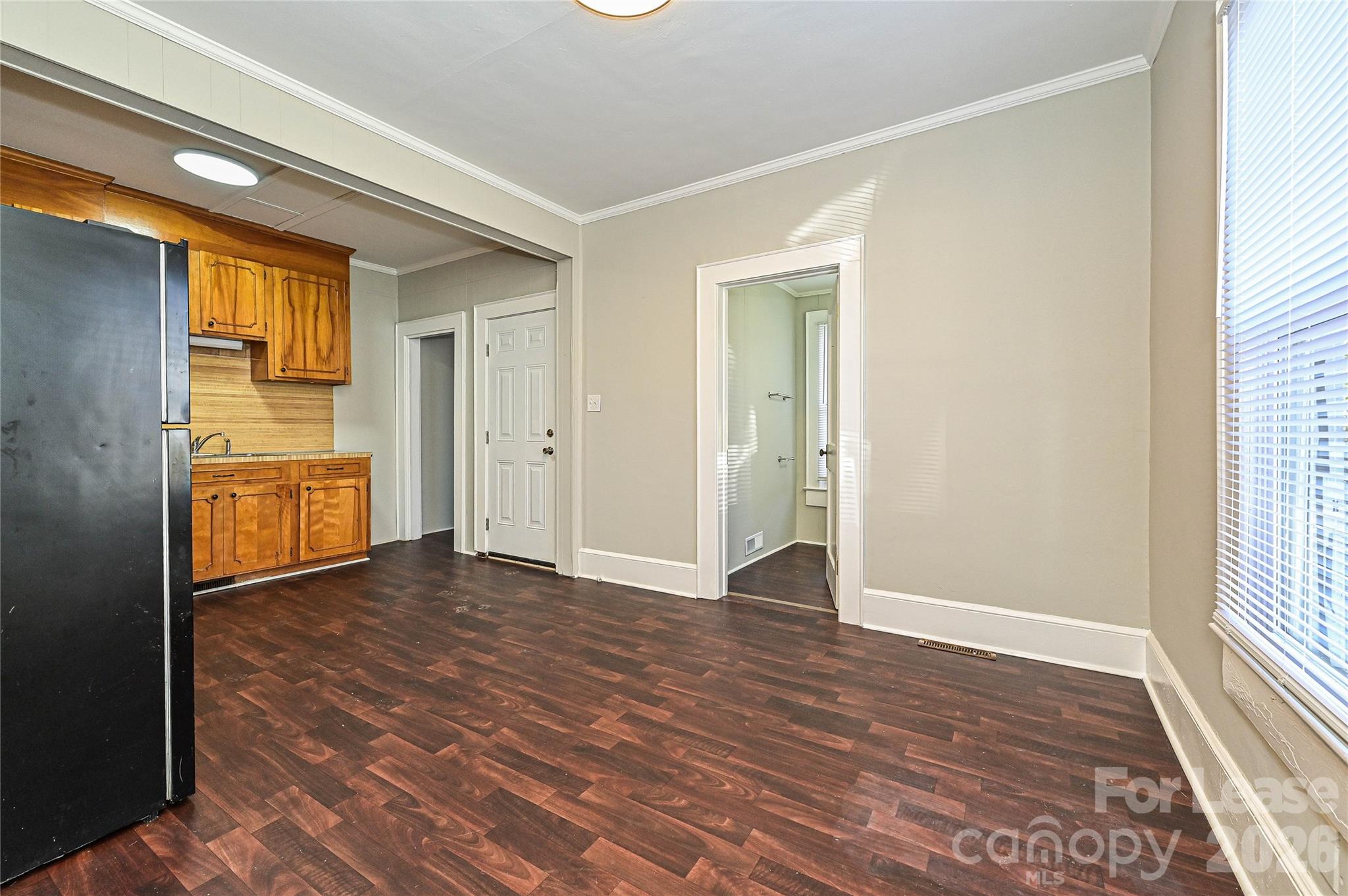 134 Saluda Street, Unit B Chester, SC 29706 - Photo 6 of 21 an empty room with windows and cabinet