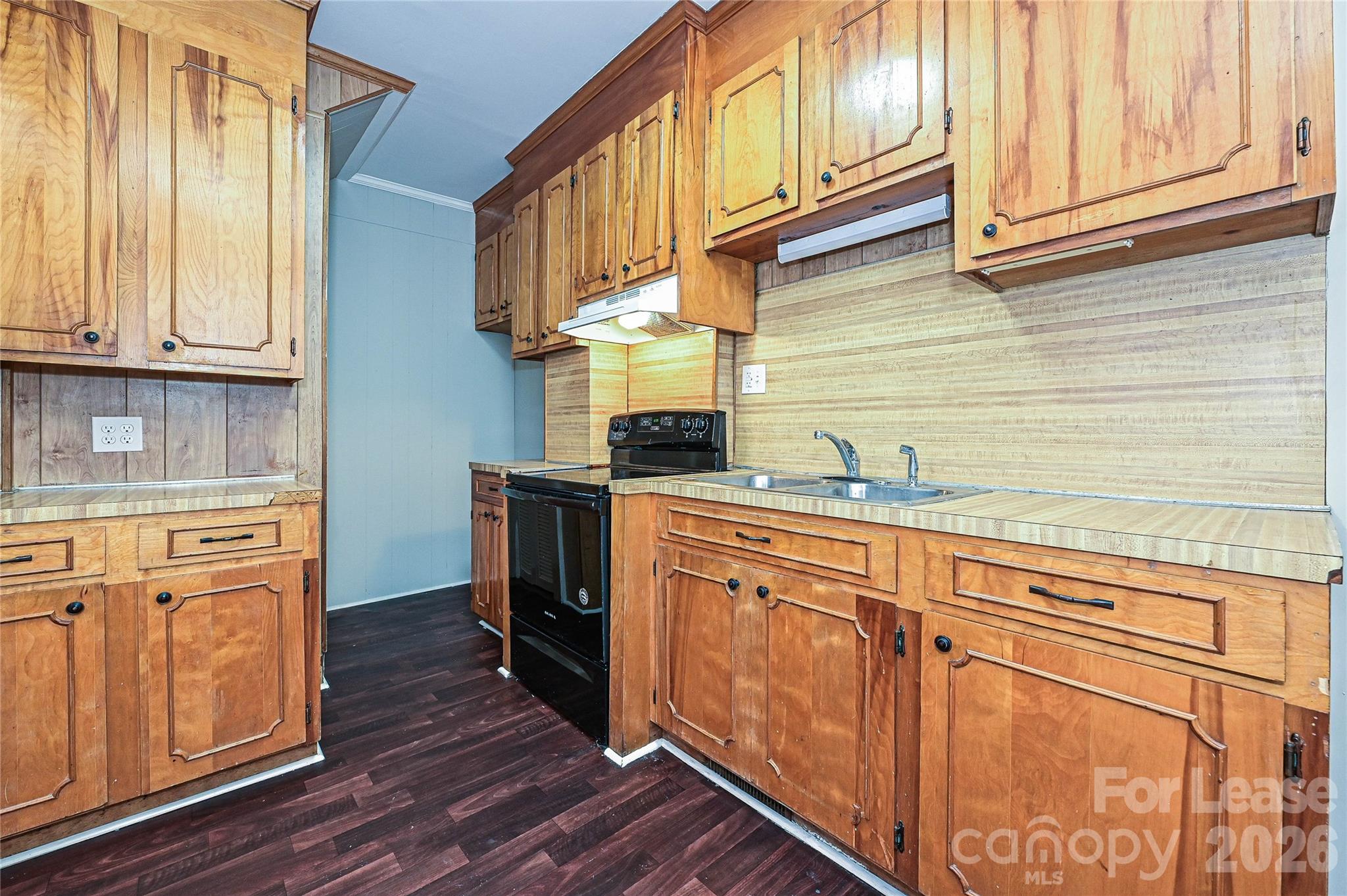 134 Saluda Street, Unit B Chester, SC 29706 - Photo 8 of 21 a kitchen with stainless steel appliances granite countertop a refrigerator a sink dishwasher and wooden cabinets with wooden floor