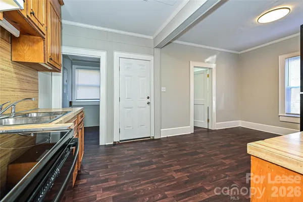 a view of a kitchen with a sink cabinets and wooden floor