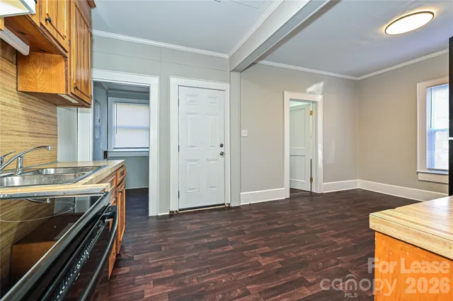 a view of a kitchen with a sink cabinets and wooden floor