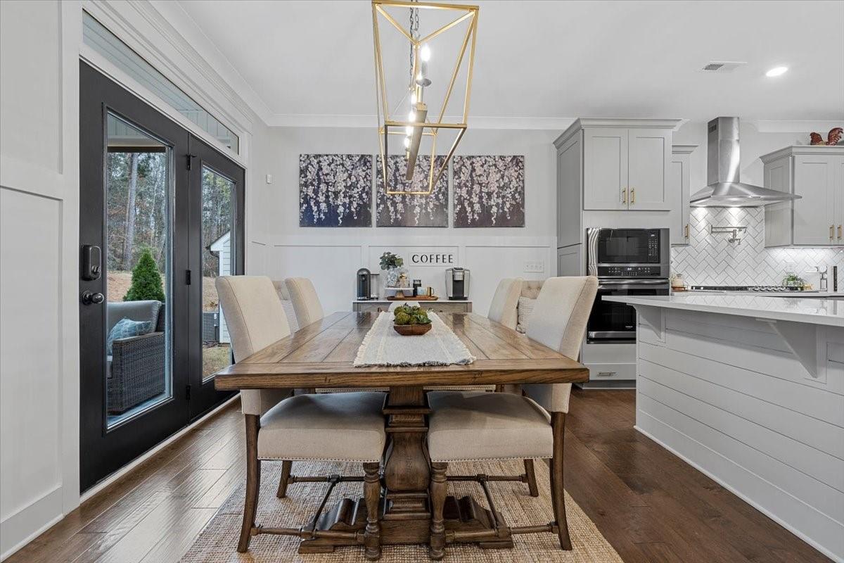 1112 Baldwin Drive Lancaster, SC 29720 - Photo 12 of 48 a view of a dining room with furniture wooden floor and a chandelier