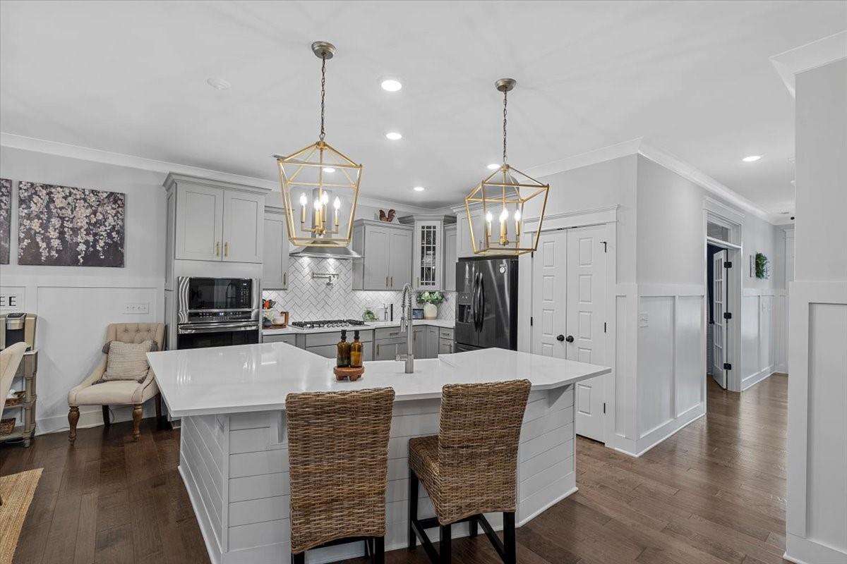 1112 Baldwin Drive Lancaster, SC 29720 - Photo 13 of 48 a kitchen with stainless steel appliances kitchen island granite countertop a dining table chairs sink and cabinets