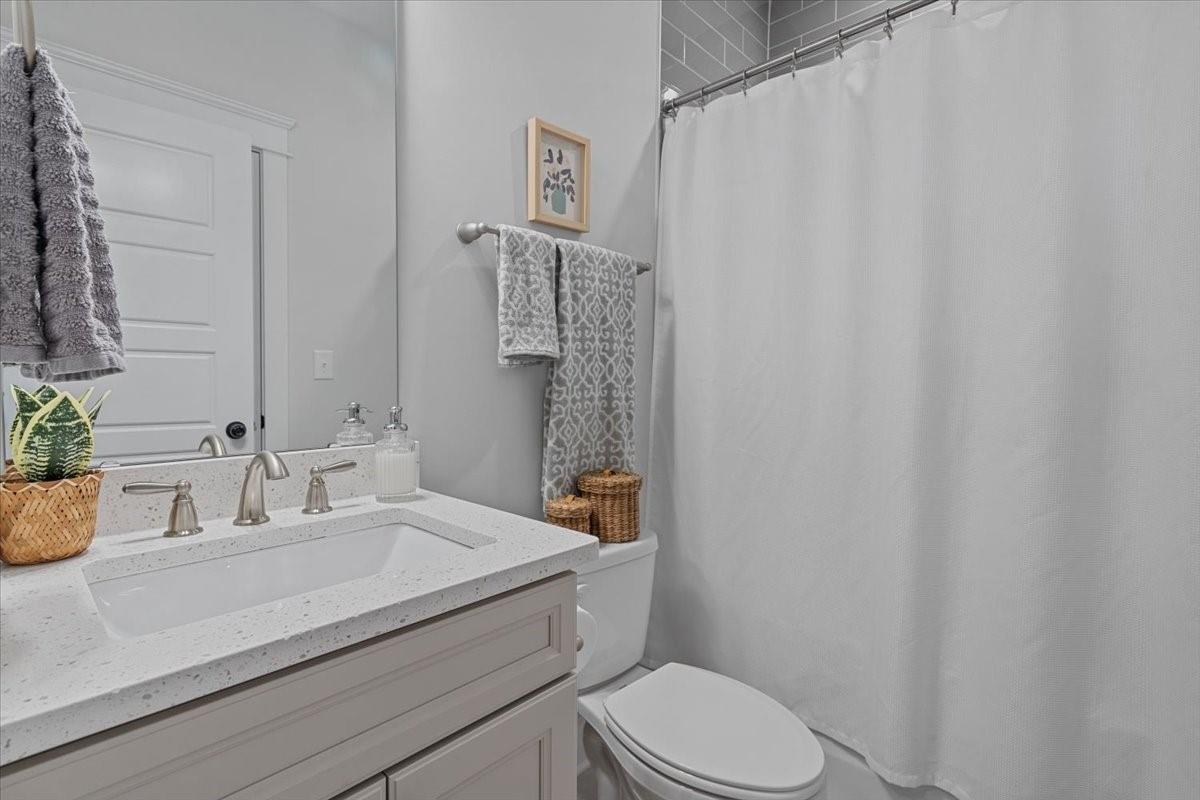 1112 Baldwin Drive Lancaster, SC 29720 - Photo 21 of 48 a bathroom with a sink a toilet and shower curtain