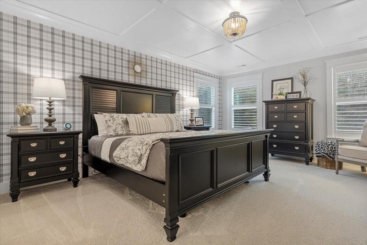 1112 Baldwin Drive Lancaster, SC 29720 - Photo 24 of 48 a bedroom with a bed and a chandelier