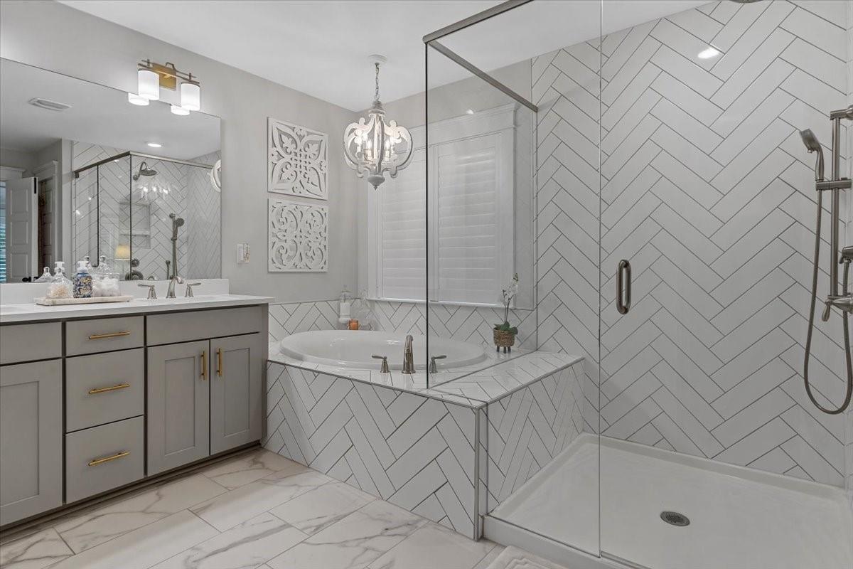 1112 Baldwin Drive Lancaster, SC 29720 - Photo 26 of 48 a spacious bathroom with a sink a mirror a bathtub and shower