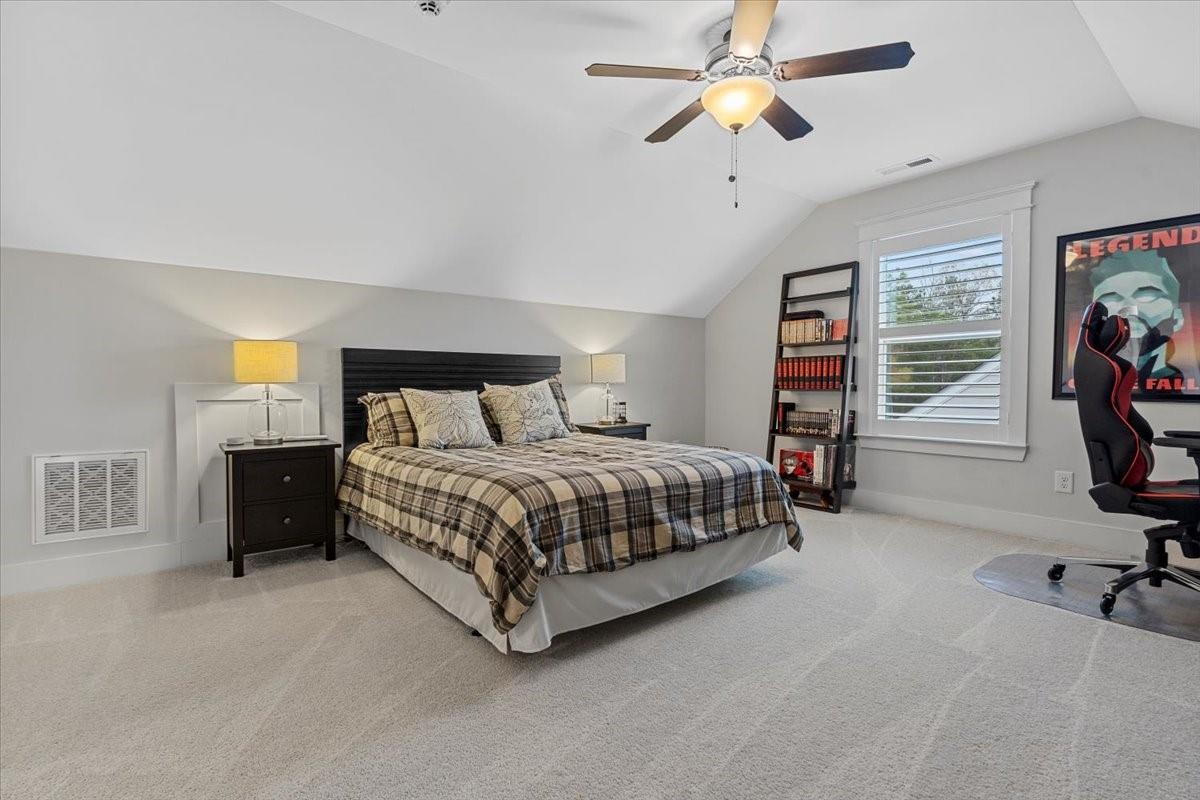 1112 Baldwin Drive Lancaster, SC 29720 - Photo 40 of 48 a bedroom with a bed and a chandelier