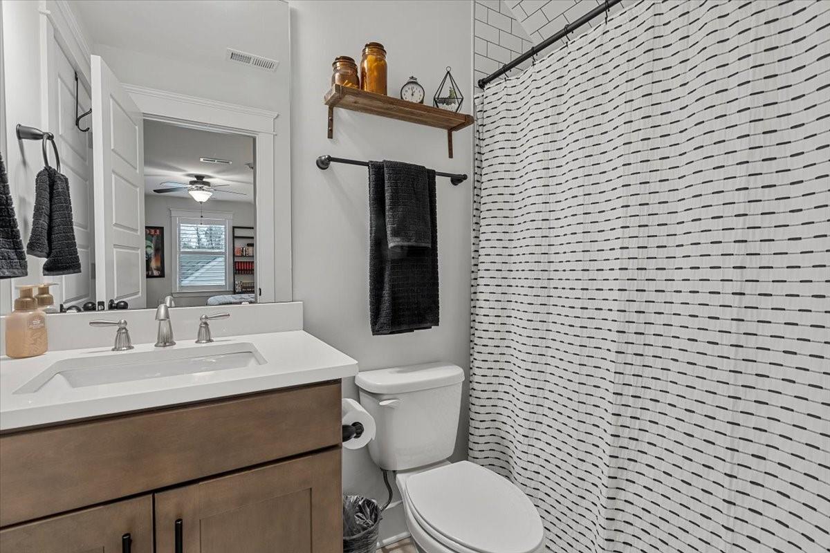 1112 Baldwin Drive Lancaster, SC 29720 - Photo 41 of 48 a bathroom with a toilet sink and mirror