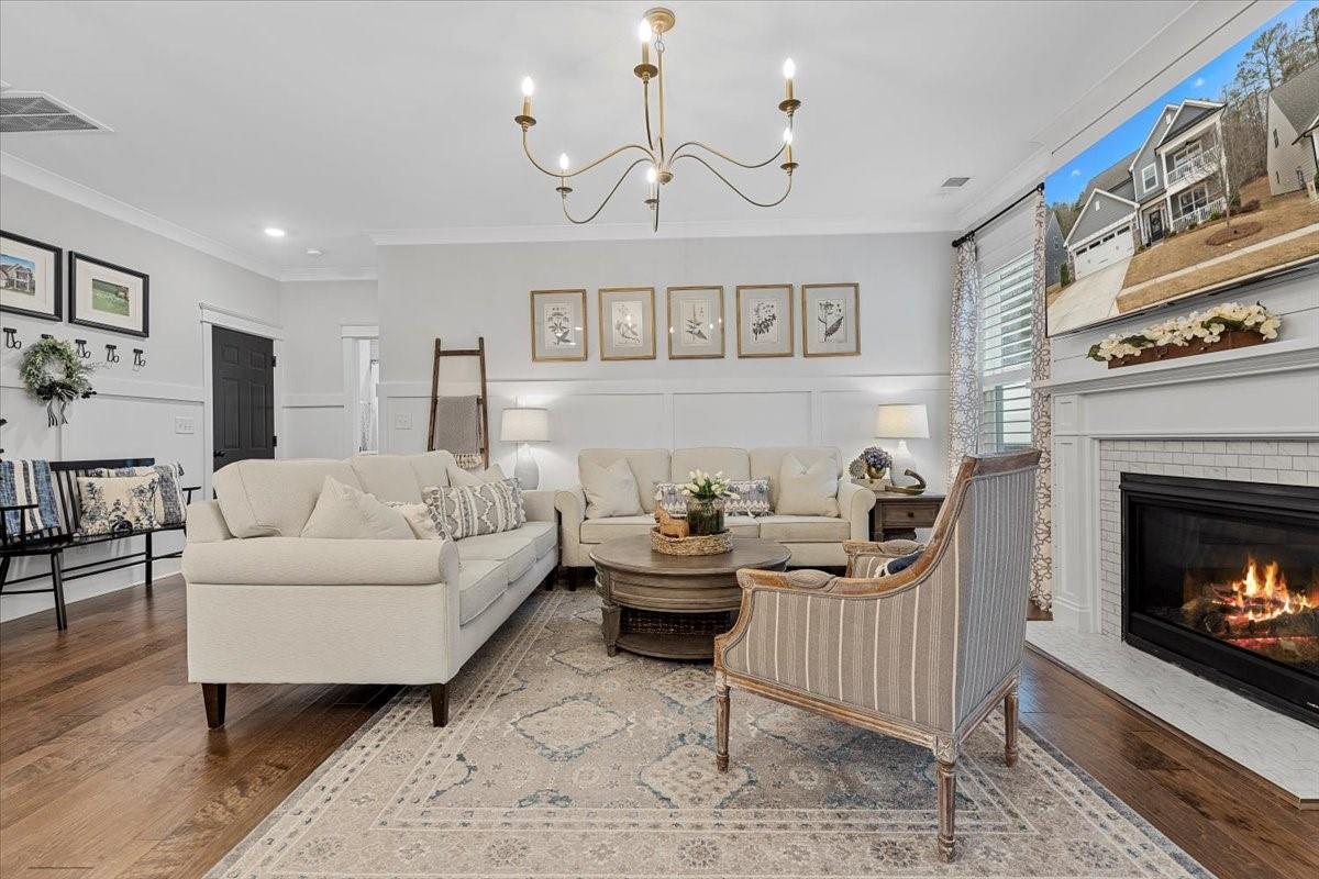 1112 Baldwin Drive Lancaster, SC 29720 - Photo 9 of 48 a living room with furniture a fireplace and a chandelier
