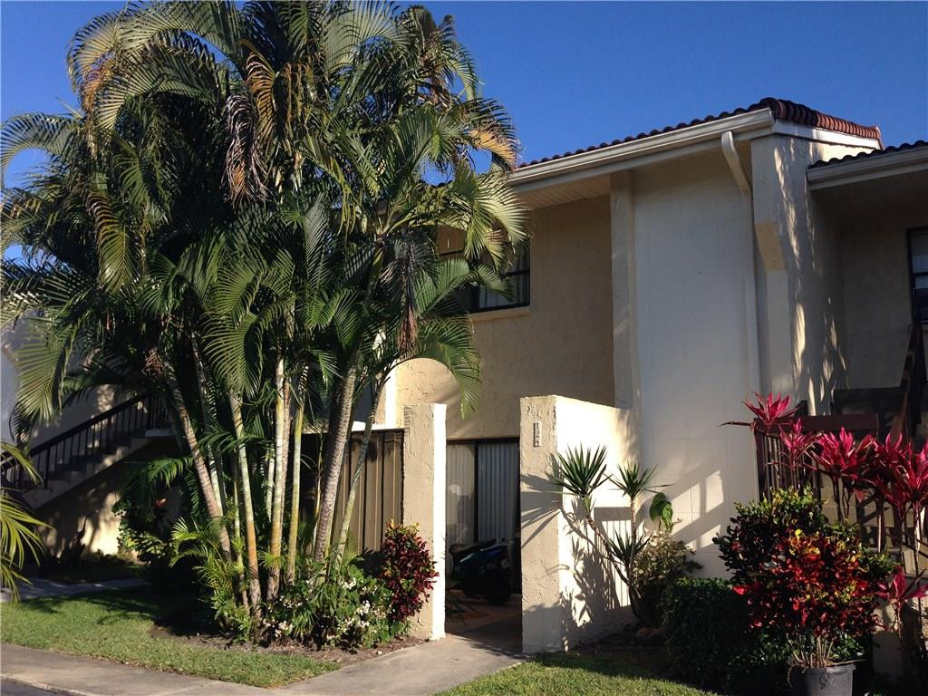 22435 Southwest 61st Way, Unit B124 Boca Raton, FL 33428 - Photo 1 of 35 a front view of a house with a yard