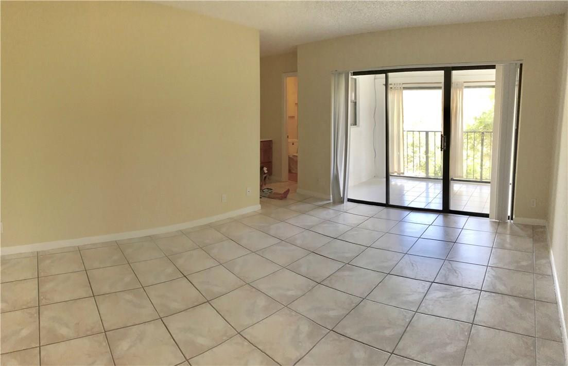 22435 Southwest 61st Way, Unit B124 Boca Raton, FL 33428 - Photo 12 of 35 a view of an empty room and window