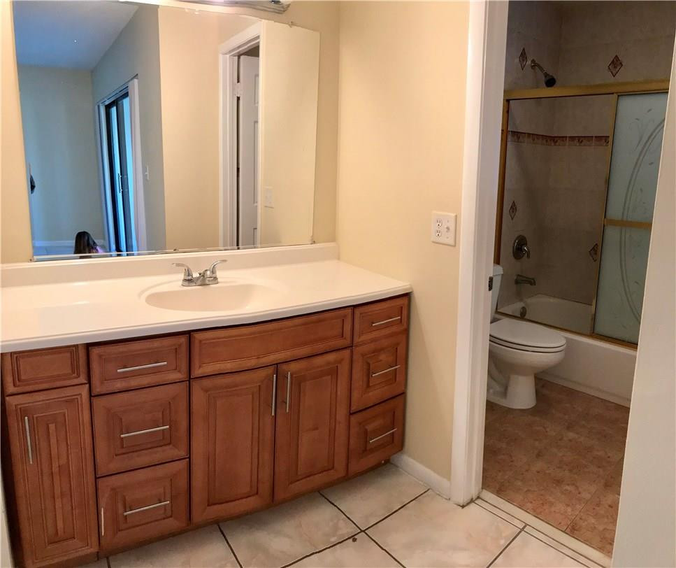 22435 Southwest 61st Way, Unit B124 Boca Raton, FL 33428 - Photo 16 of 35 a bathroom with a sink a toilet and shower