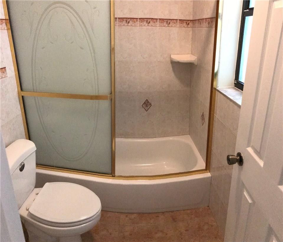 22435 Southwest 61st Way, Unit B124 Boca Raton, FL 33428 - Photo 17 of 35 a bathroom with a toilet and a shower