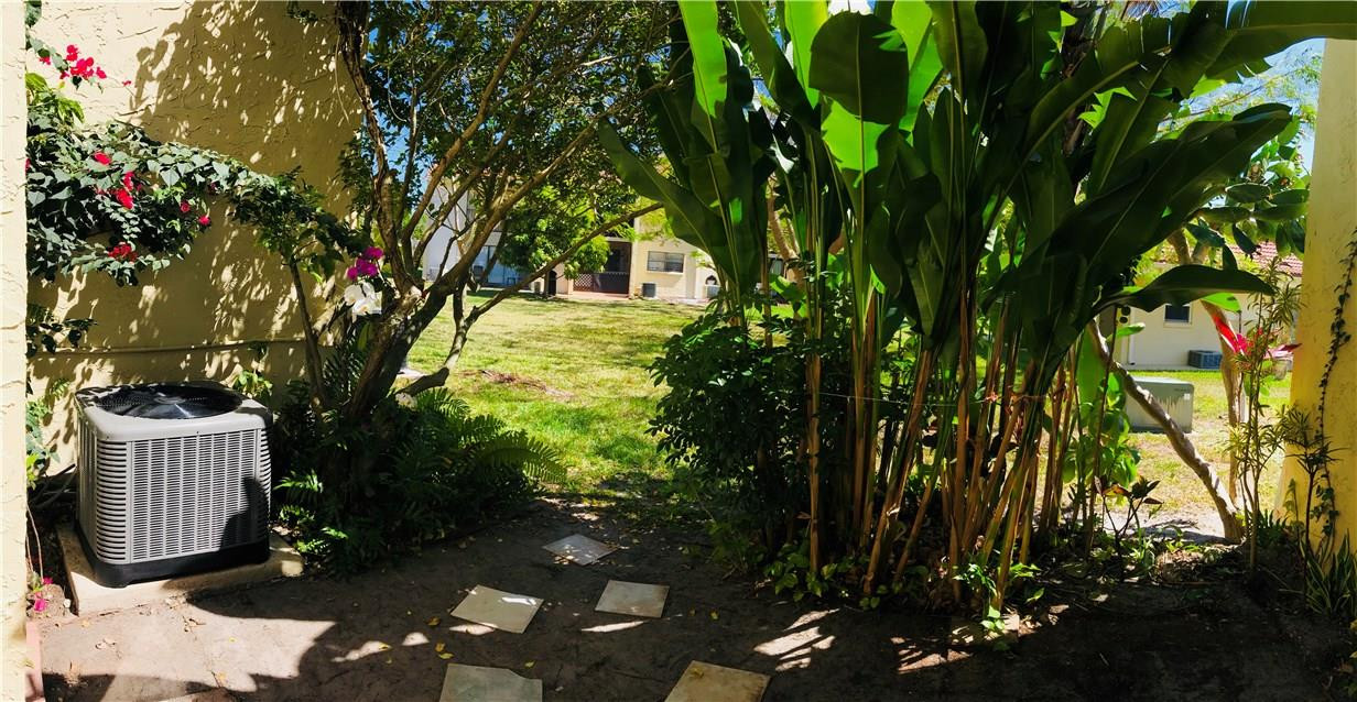22435 Southwest 61st Way, Unit B124 Boca Raton, FL 33428 - Photo 18 of 35 a view of an outdoor space and a yard