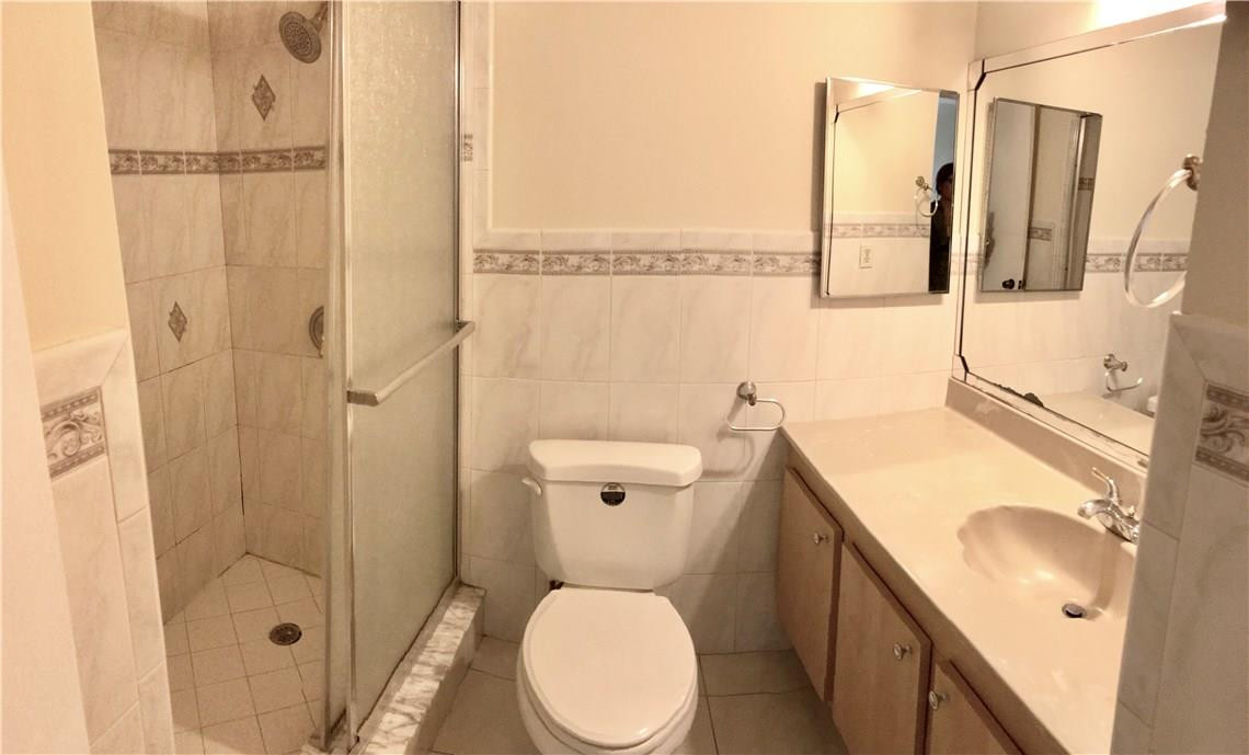 22435 Southwest 61st Way, Unit B124 Boca Raton, FL 33428 - Photo 21 of 35 a bathroom with a sink a toilet and shower