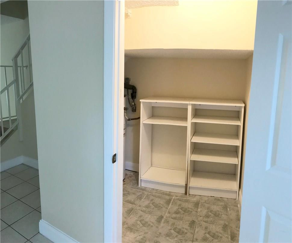 22435 Southwest 61st Way, Unit B124 Boca Raton, FL 33428 - Photo 23 of 35 a view of walk in closet with empty racks