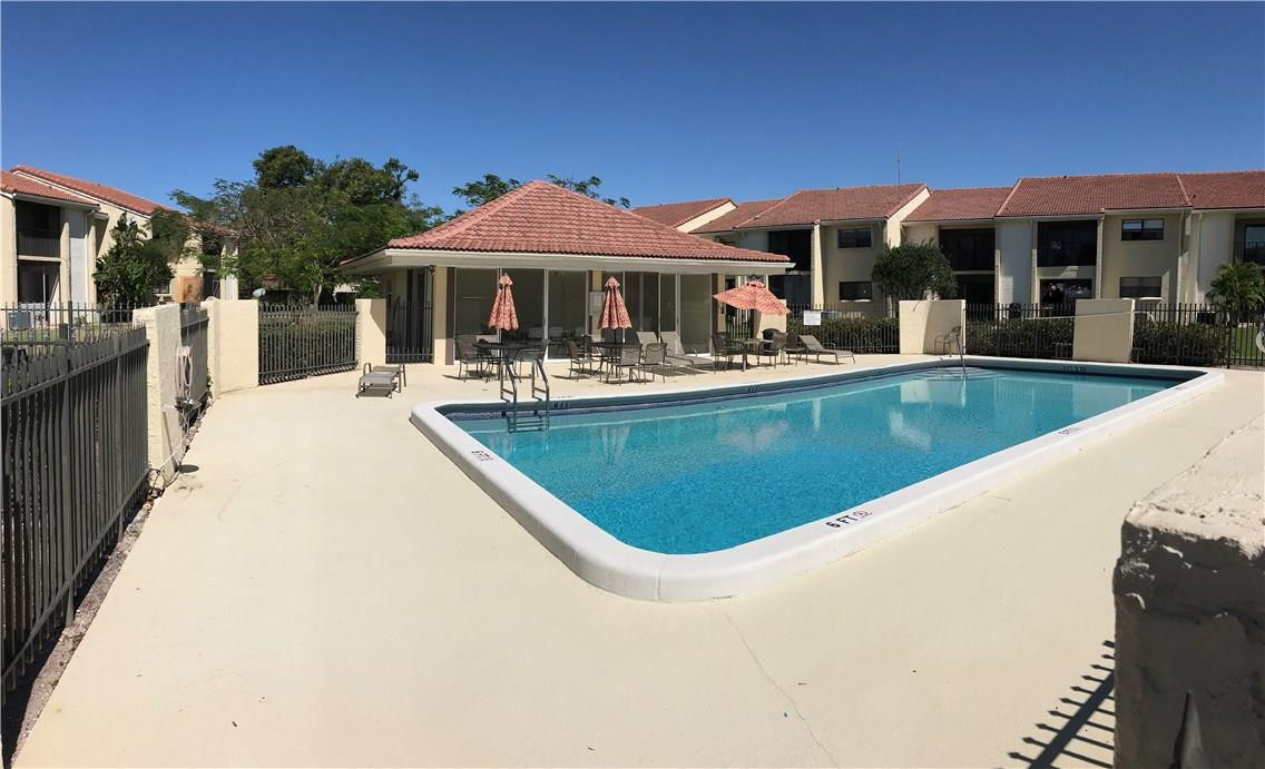 22435 Southwest 61st Way, Unit B124 Boca Raton, FL 33428 - Photo 27 of 35 a view of a house with pool and chairs