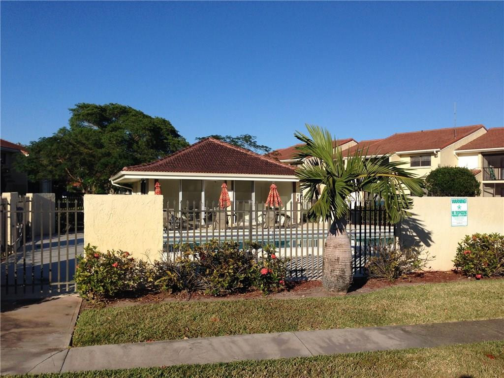 22435 Southwest 61st Way, Unit B124 Boca Raton, FL 33428 - Photo 31 of 35 a front view of a house with a garden
