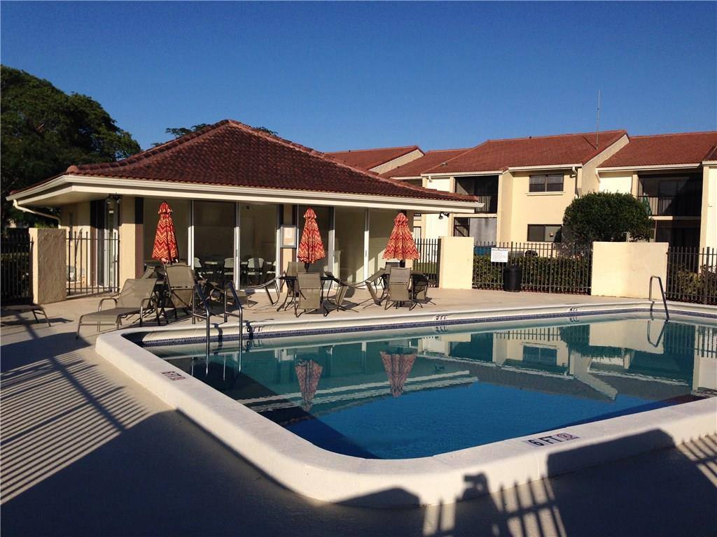 22435 Southwest 61st Way, Unit B124 Boca Raton, FL 33428 - Photo 32 of 35 a view of a patio with swimming pool table and chairs
