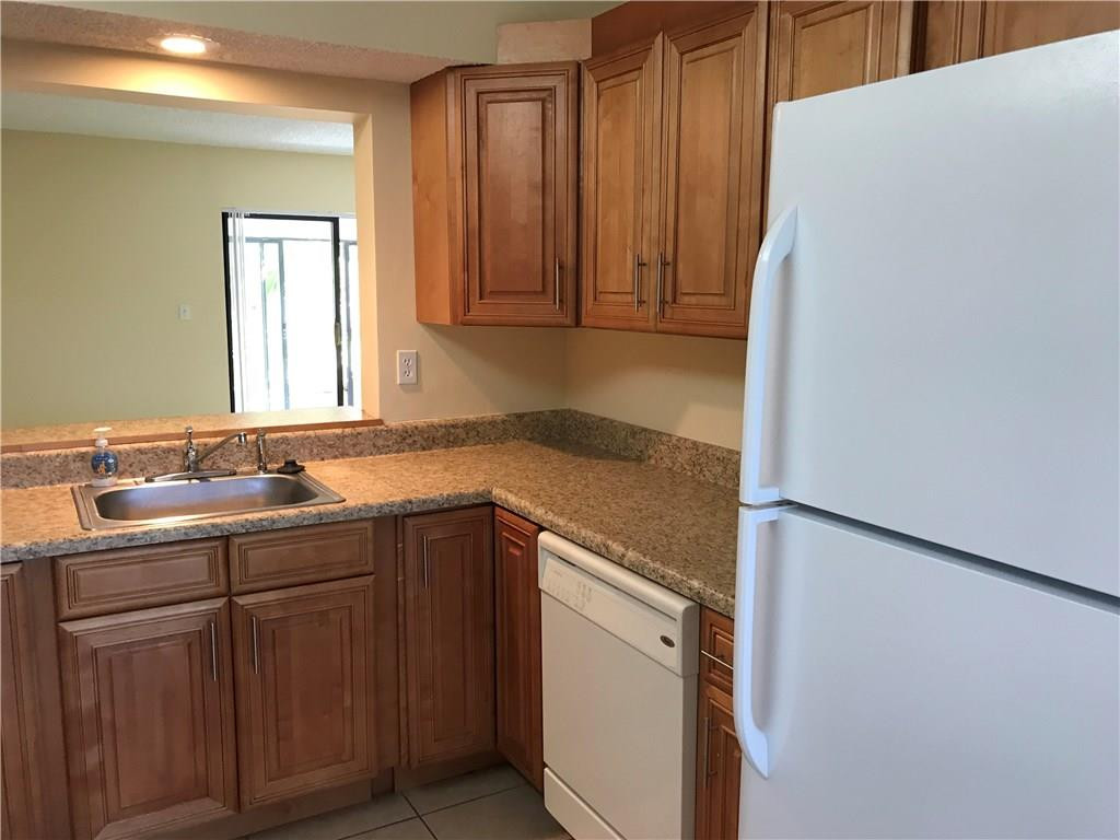 22435 Southwest 61st Way, Unit B124 Boca Raton, FL 33428 - Photo 5 of 35 a kitchen with a sink and cabinets