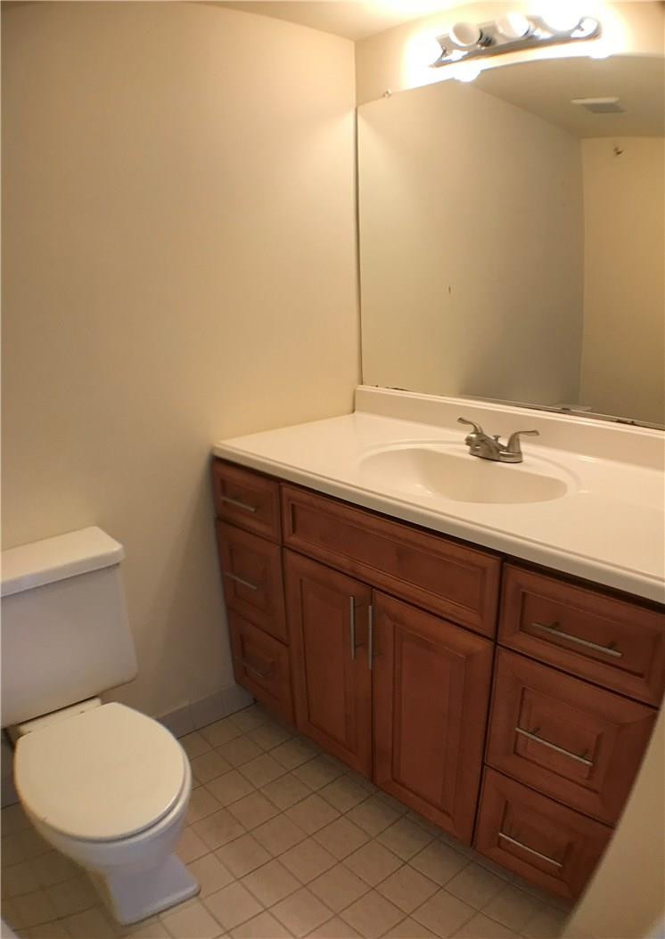 22435 Southwest 61st Way, Unit B124 Boca Raton, FL 33428 - Photo 6 of 35 a bathroom with a toilet sink and mirror