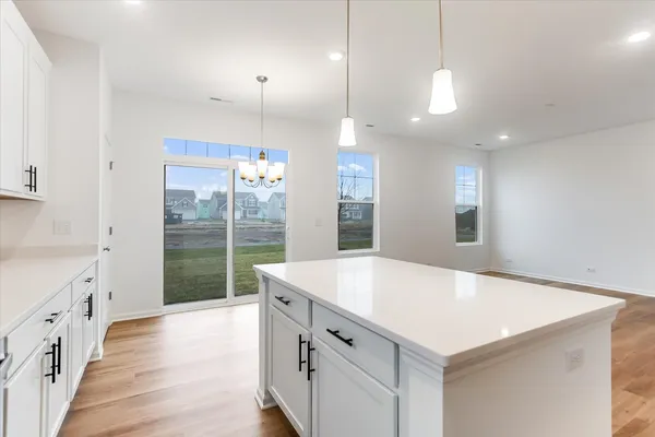 a large white kitchen with a large window