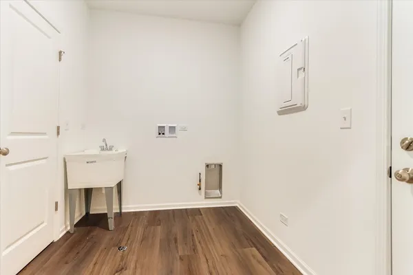 a view of a room with wooden floor