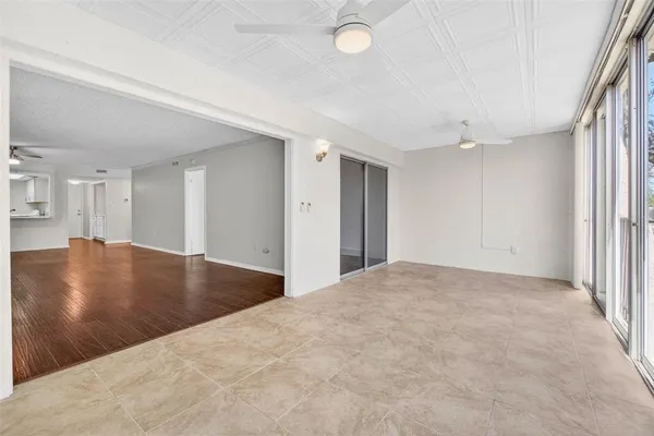 a view of a livingroom with a hall and kitchen view