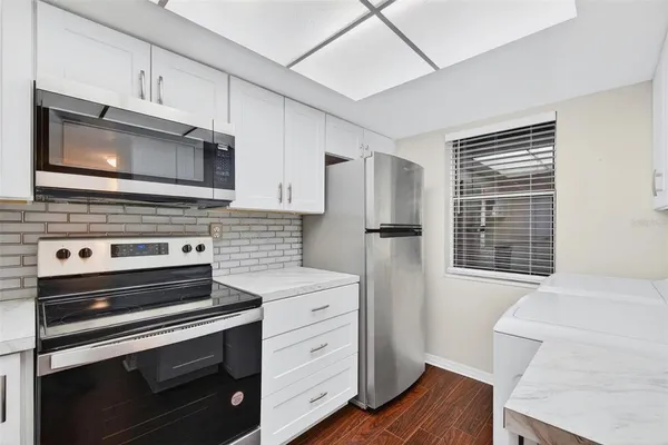 a kitchen with a stove microwave and refrigerator