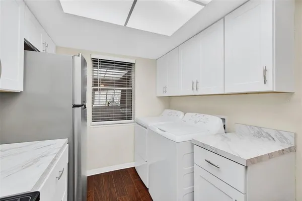 a view of a kitchen with sink and cabinets