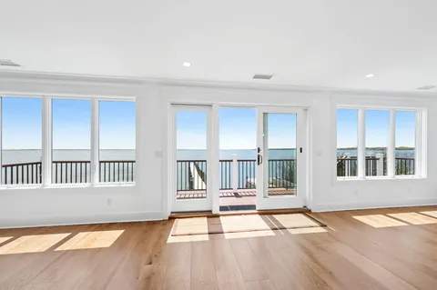 a view of a room with wooden floor and fireplace