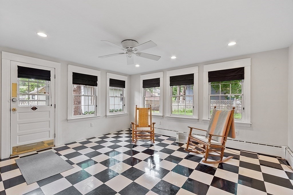 65 Commodore Road Worcester, MA 01602 - Photo 14 of 33 a living room with a black white checkered floor with a gaming machine and dining chair