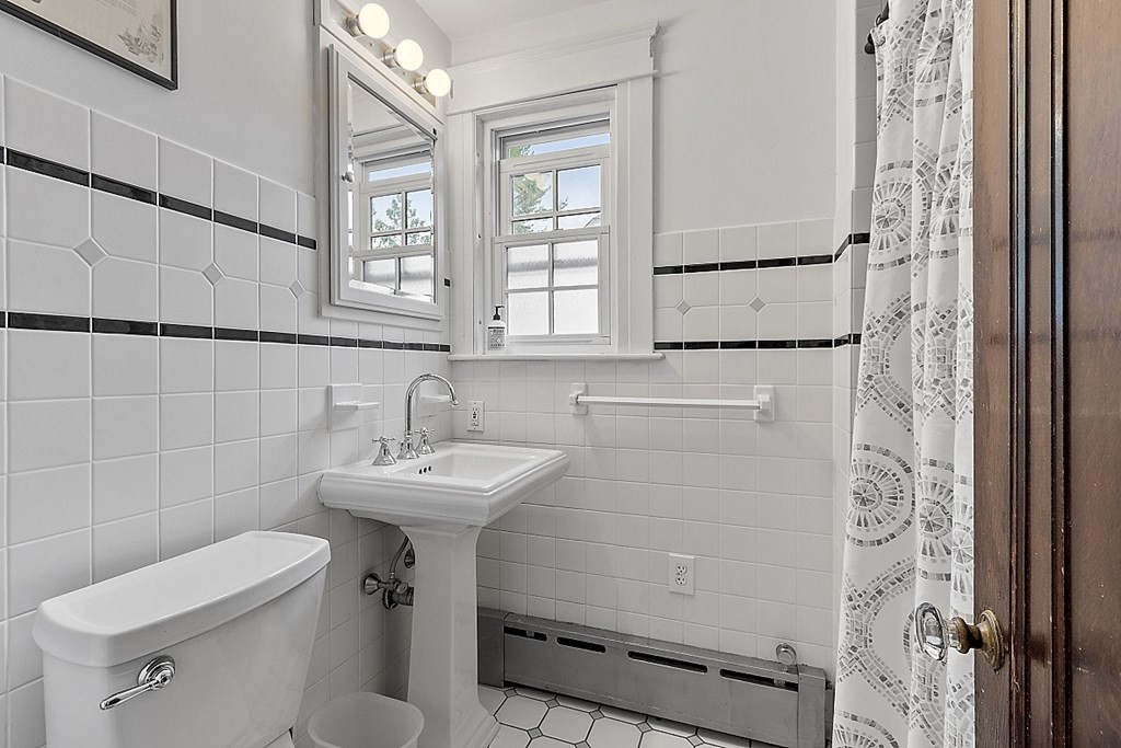 65 Commodore Road Worcester, MA 01602 - Photo 26 of 33 a bathroom with a sink a toilet and a mirror