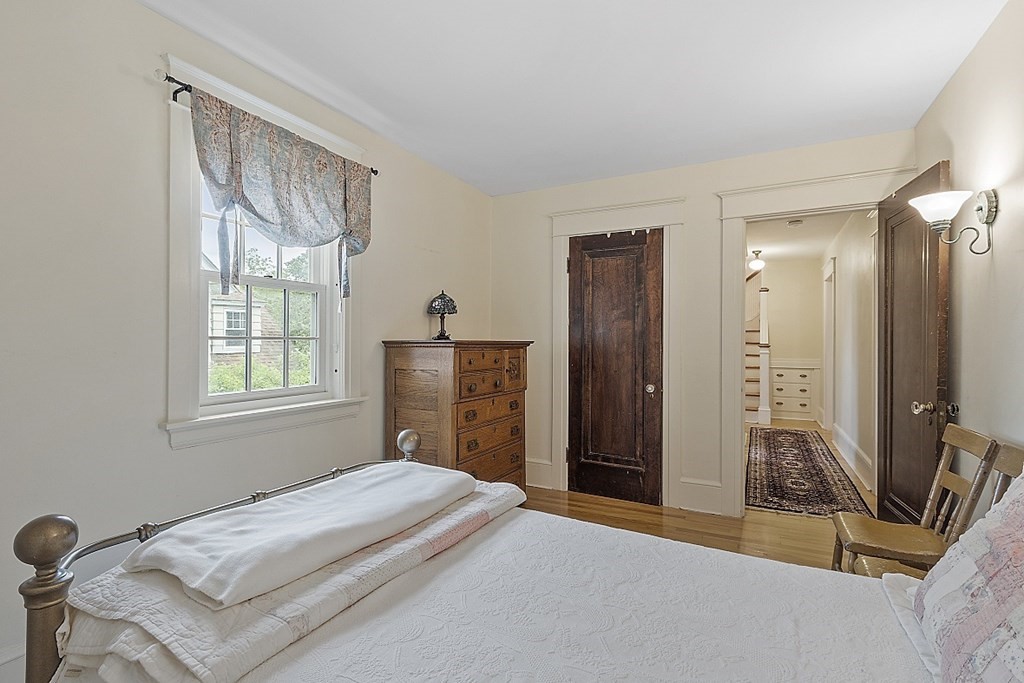 65 Commodore Road Worcester, MA 01602 - Photo 27 of 33 a bedroom with a bed and a dresser with mirror