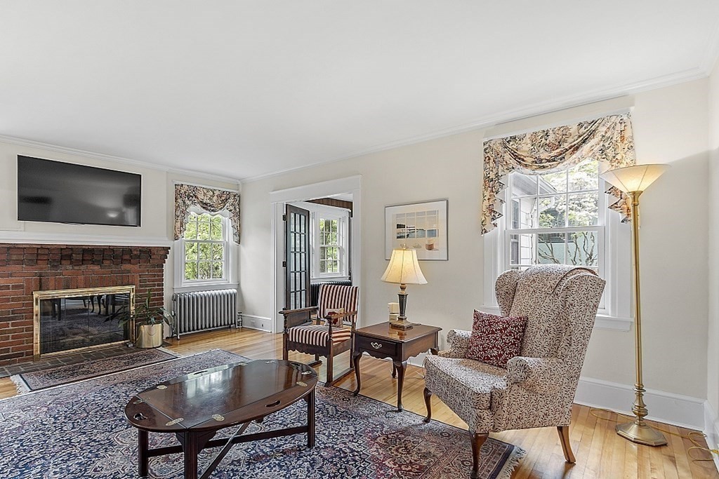 65 Commodore Road Worcester, MA 01602 - Photo 9 of 33 a living room with furniture a flat screen tv and a fireplace