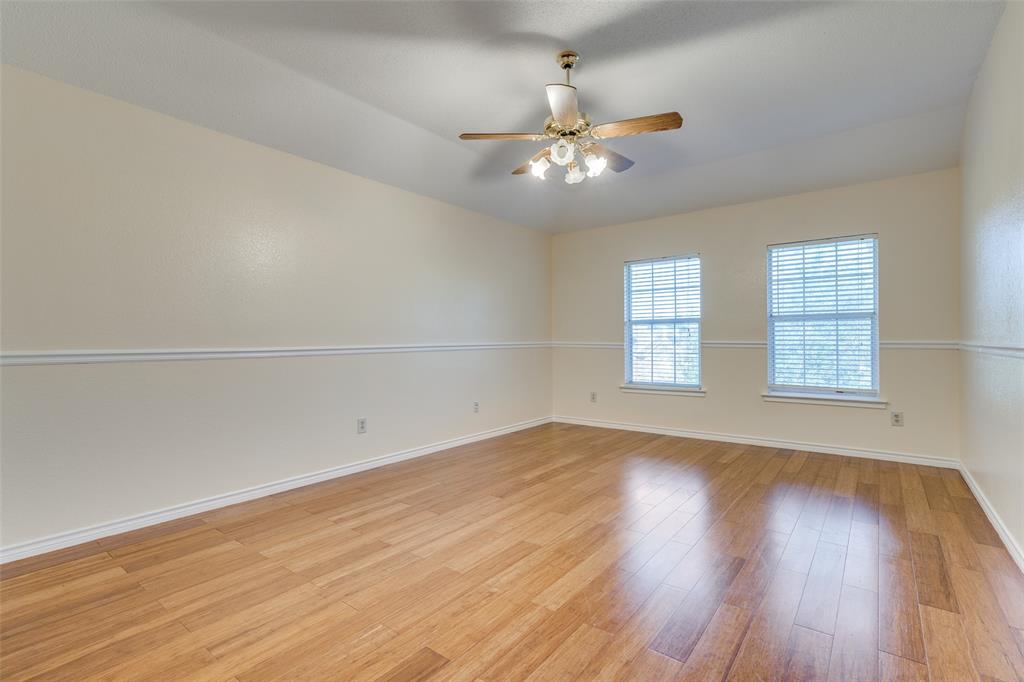 8305 Camden Court Rowlett, TX 75089 - Photo 11 of 18 Empty room featuring light wood-type flooring and ceiling fan