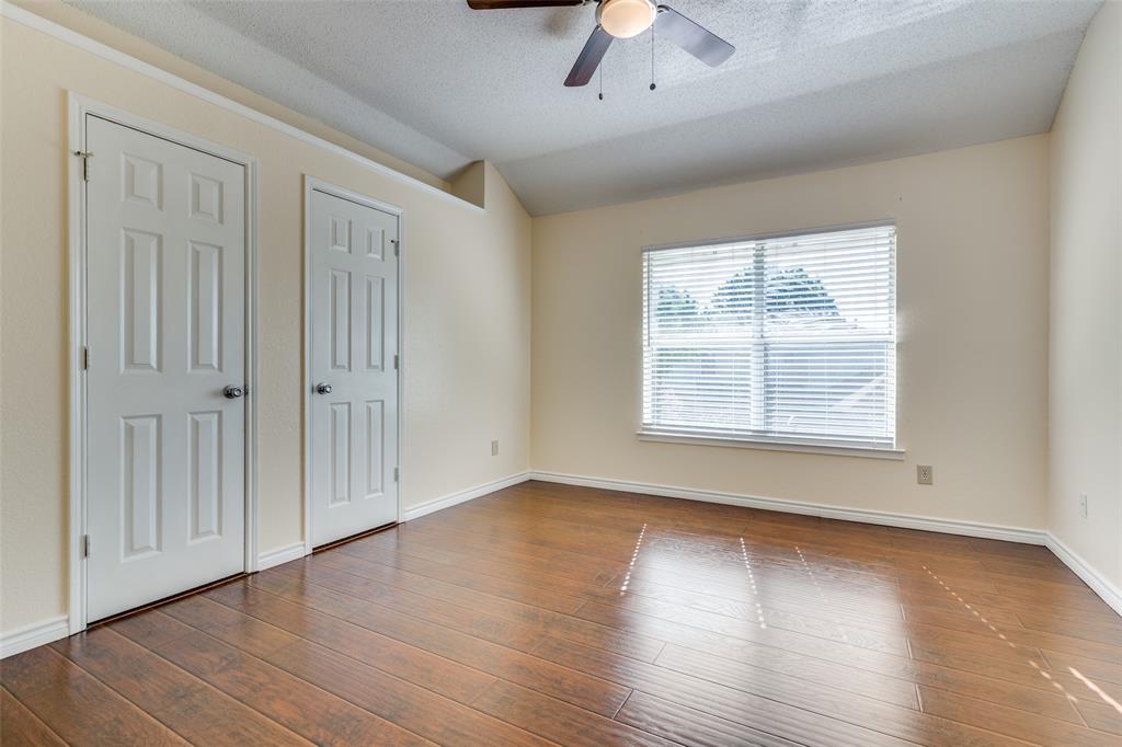 8305 Camden Court Rowlett, TX 75089 - Photo 15 of 18 Unfurnished bedroom featuring dark wood-style flooring, a textured ceiling, and ceiling fan